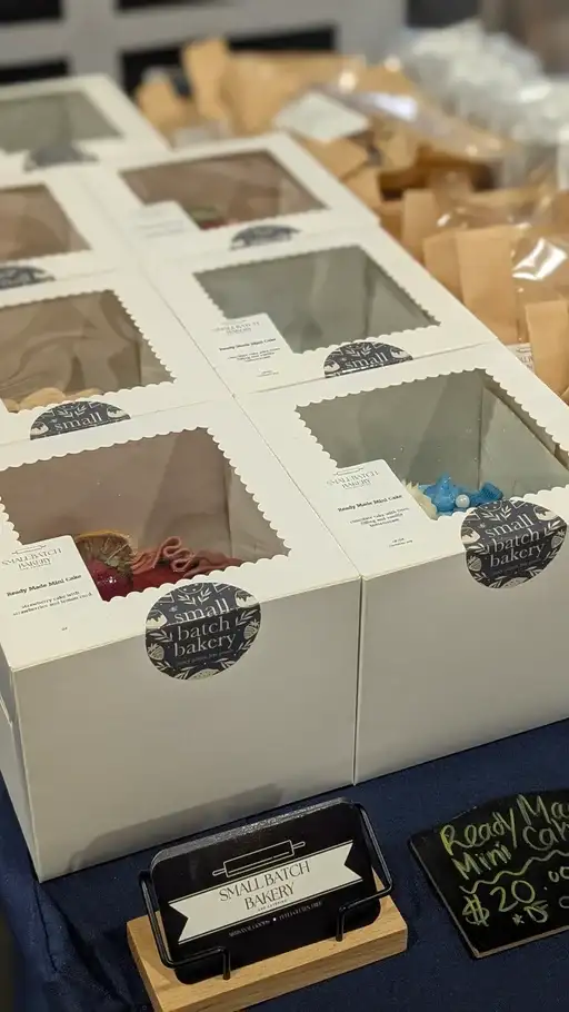 Image of packaged cakes for sale at a farmers market