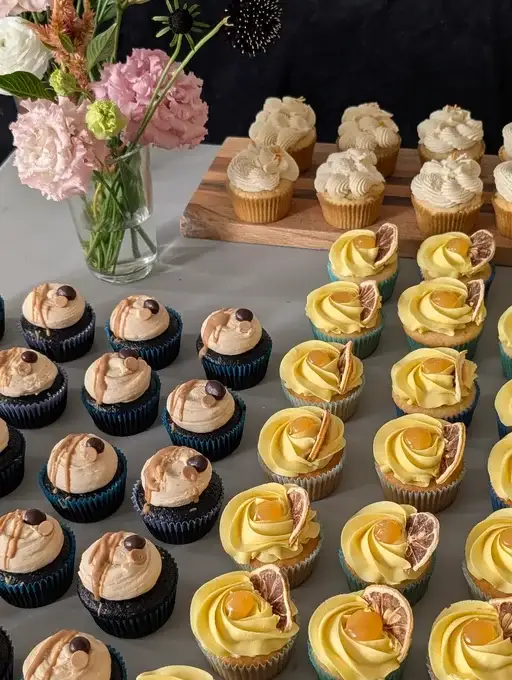 A table filled with assorted gluten-free cupcakes